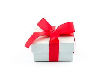 White gift box with red ribbon bow isolated on white background.