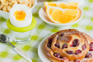 Soft boiled chicken egg, baking, muesli and orange