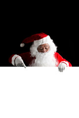 Santa Claus holding a white blank sign isolated on black  background