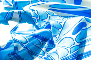 Texture, background, pattern. A woman's silk handkerchief. Shawl abstract pattern, blue patterns on...