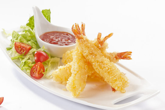 Tempura Jumbo Shrimps with salad and salsa dip on white plate and white background