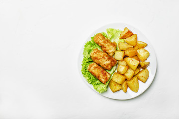 Fish and chips on a plate, white background, top view