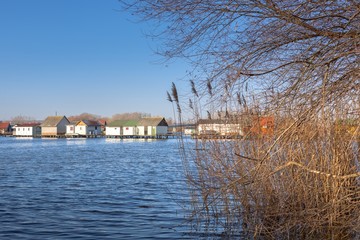 Fototapeta premium Wooden house on the lake at winter