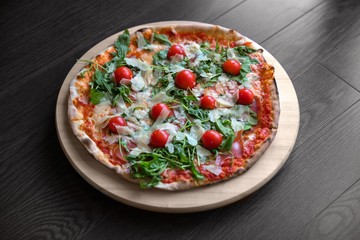 Delicious pizza on wooden background closeup photo