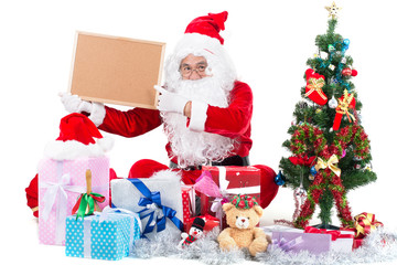 happy santa claus man with gift box around and holding sign for you text.