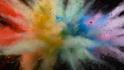 Colorful powder/particles fly after being exploded against black background. Shot with high speed camera, phantom flex 4K. Slow Motion.