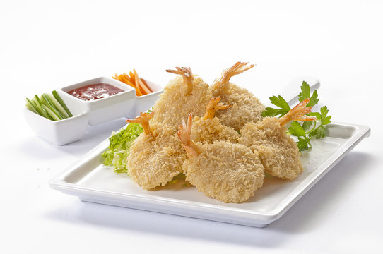 Breaded Butterfly Jumbo Shrimps with salad and salsa dip on white plate and white background 