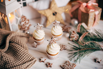 Christmas delicious cupcakes decorated with a gingerbread star. Christmas background.