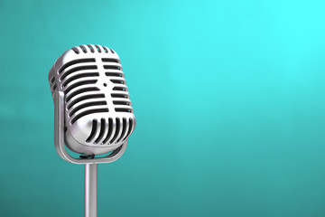 Retro microphone with turquoise wall background