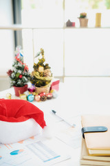  Group of young business people are sitting in Santa hats in last working day. young creative people are celebrating holiday in modern office. Merry Christmas and Happy New Year 2018