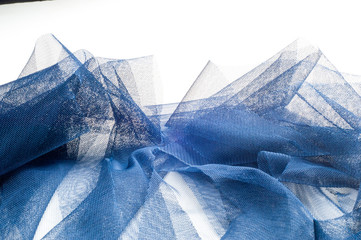 Texture, background, pattern. Blue ribbon in a small grid. Wide blue tulle gauze mesh fabric...