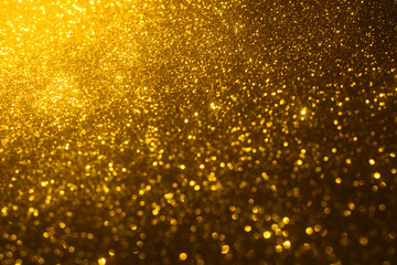 Fototapeta na wymiar golden glitter texture Colorfull Blurred abstract background for birthday, anniversary, wedding, new year eve or Christmas.
