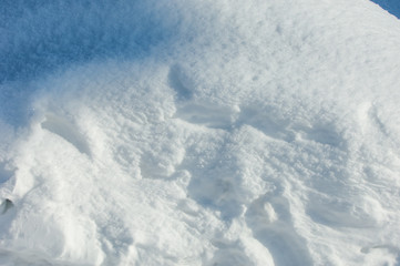 Texture, background, pattern. Footprints in the snow. The frost is very cold. White snow blanket on...