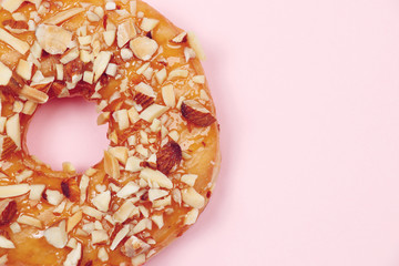 Delicious donut with almond caramel glazed, Isolated on pink background.