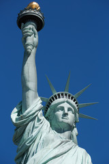Fototapeta na wymiar Statue of Liberty, upper part detail in New York, blue sky