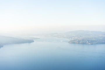 Fototapeta na wymiar view of lake lucerne from buergenstock with fog sky