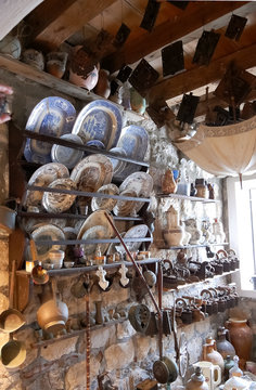 Variety of old household items on shelves collected in church as a gift, Montenegro.