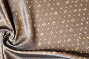 Texture background pattern. Brown silk fabric. Abstract background of luxury fabrics or liquid...
