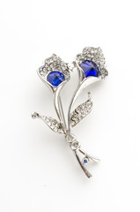 silver brooch flower with blue stone isolated on white