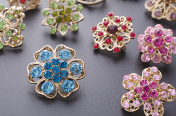 set of brooches isolated on black. background of many brooches