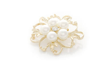 gold brooch flower with pearl isolated on white