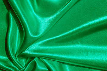 Texture, fabric, background. Abstract background of luxurious fabric or liquid waves or wavy grunge crease silk satin texture of velvet material or luxurious Christmas or elegant background. green