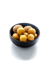 Deep Fried Sweet Potato Balls in black bowl on wooden table