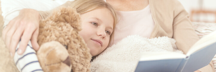 Woman reading to her daughter
