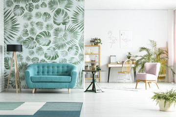 Spacious room with blue couch