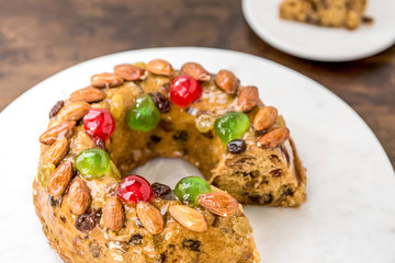 Beautiful delicious homemade  Christmas fruit cake on white platter