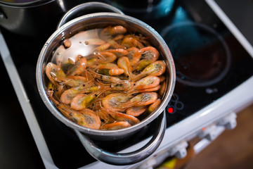 Shrimps boil in pan. Selective focus with shallow depth of field.