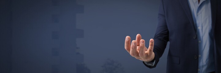 Businessman with hand palm open and dark background