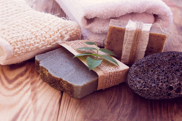 Three pieces of dry soap with a towel, pumice and a bast