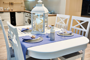 Dining table in kitchen with cutlery