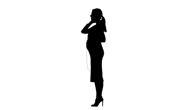 Pregnant gives music through headphones to a child in the abdomen. Silhouette. White background. Slow motion