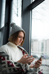 Stressed woman looking at smartphone