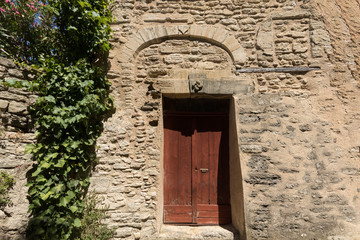 Old wooden door on stone  house  in Gordes. Provence, France
