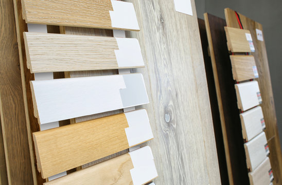 Assortment of baseboard molding and flooring samples in shop