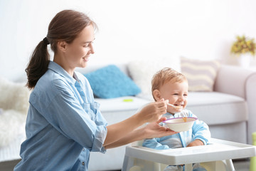 Woman feeding her baby at home
