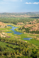 Obraz premium Looking Down on Lush River Valley in Hampi, India