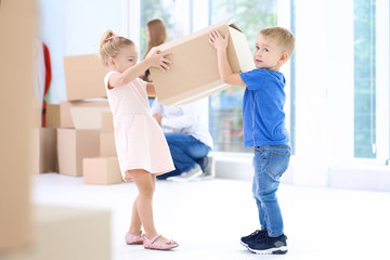 Fototapeta na wymiar Happy children with moving box in their new house
