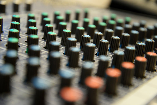 Close up of controllers of professional sound mixer.