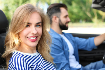 Fototapeta premium Happy young couple in car on road trip