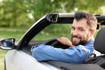 Happy young man driving a car