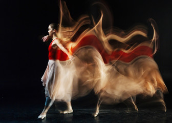 Plastic movements. Beautiful young slim woman making a step forwards and moving her hands while...
