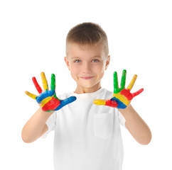 Cute little boy with hands in paint on white background