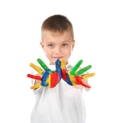 Cute little boy with hands in paint on white background