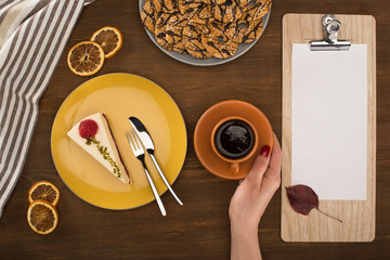 hand with coffee and pastries