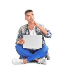 Thoughtful young man with laptop on white background