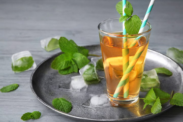 Glass with fresh apple juice on metal tray